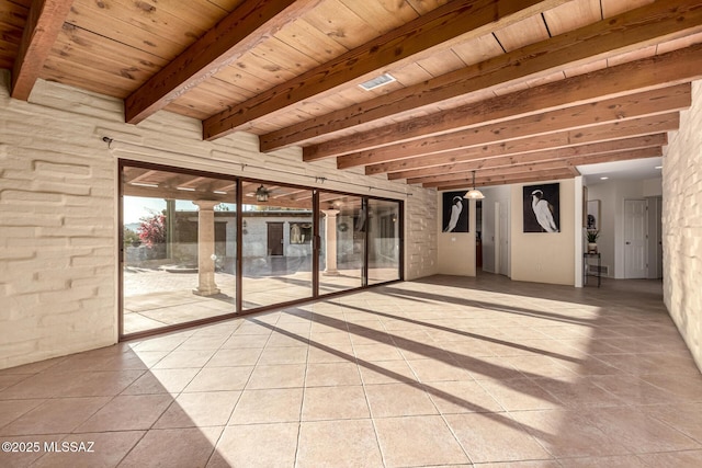 tiled empty room featuring wood ceiling and beamed ceiling