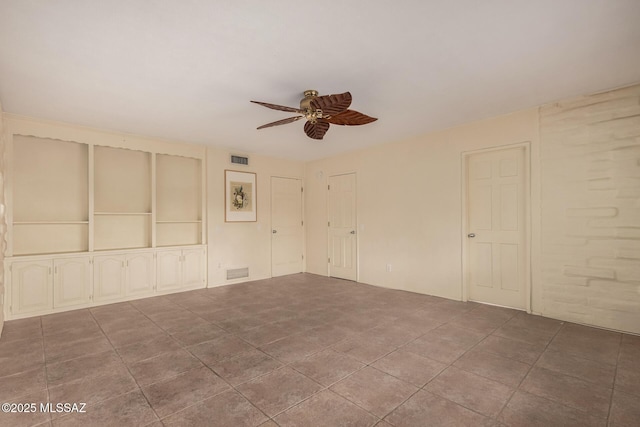 interior space with visible vents and ceiling fan