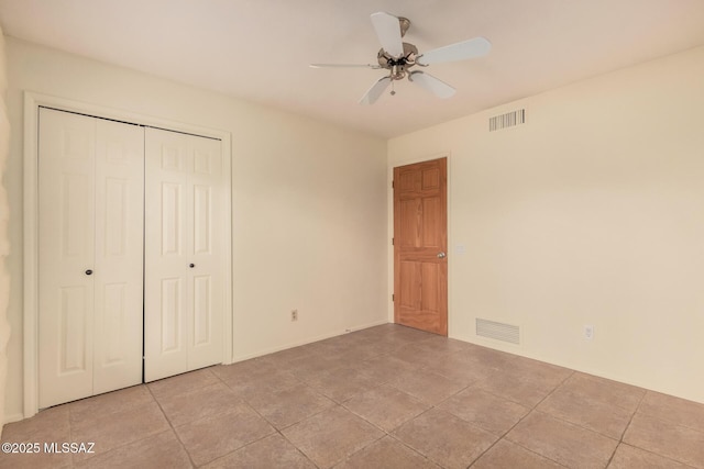 unfurnished bedroom with a closet, visible vents, and a ceiling fan