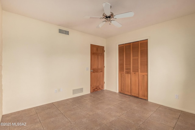 unfurnished bedroom with ceiling fan, visible vents, and a closet