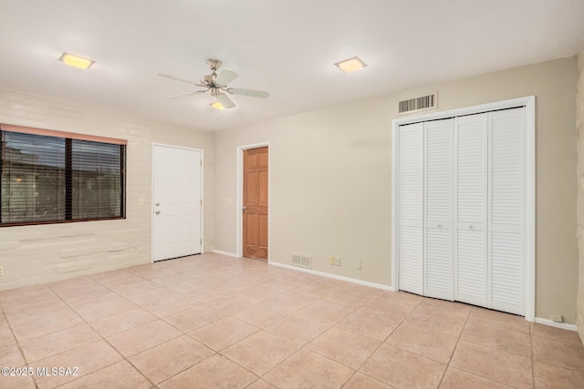 unfurnished bedroom with a ceiling fan, visible vents, a closet, and light tile patterned floors