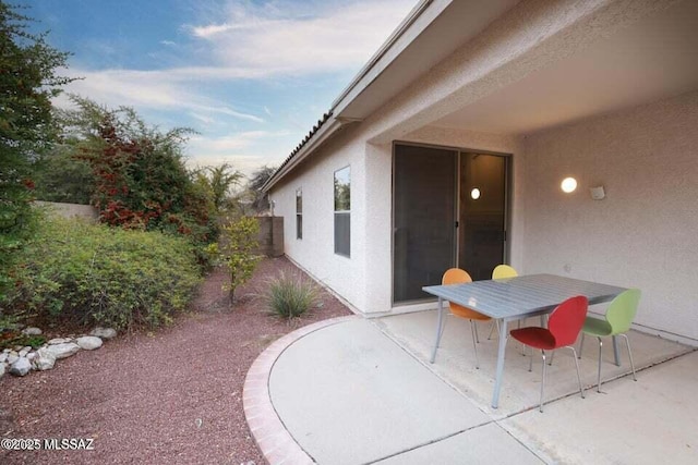 view of patio featuring fence and outdoor dining area