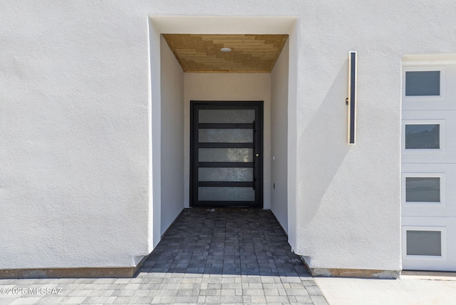 property entrance with stucco siding