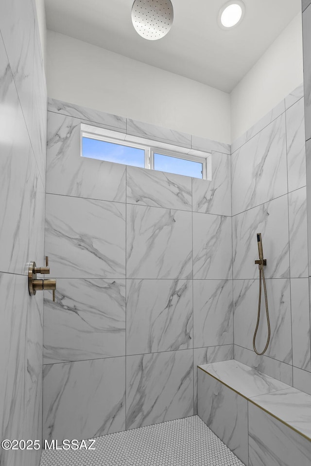 bathroom featuring a tile shower