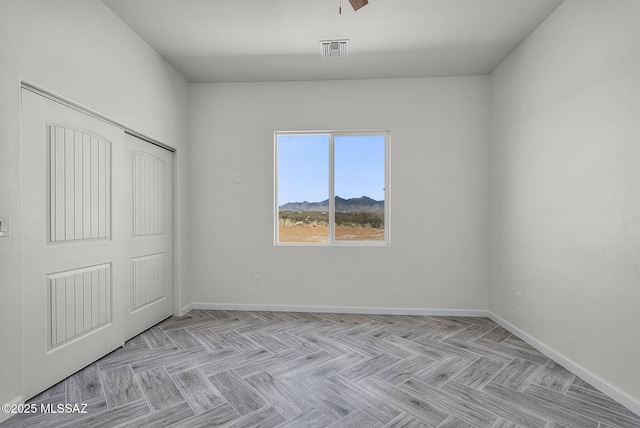 interior space with baseboards, a mountain view, and visible vents