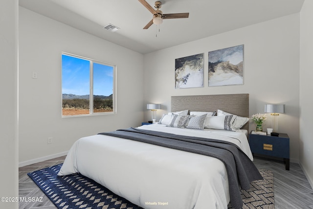 bedroom with baseboards, a ceiling fan, and visible vents