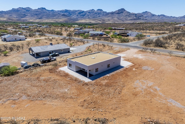 birds eye view of property featuring a mountain view and view of desert