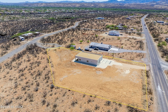 birds eye view of property featuring a mountain view, a desert view, and a rural view