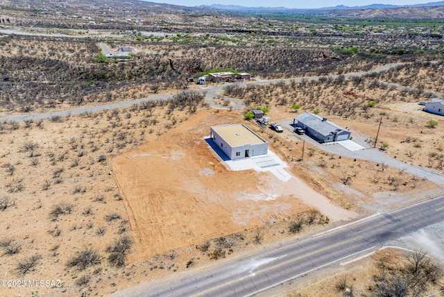 birds eye view of property with a mountain view, a rural view, and view of desert