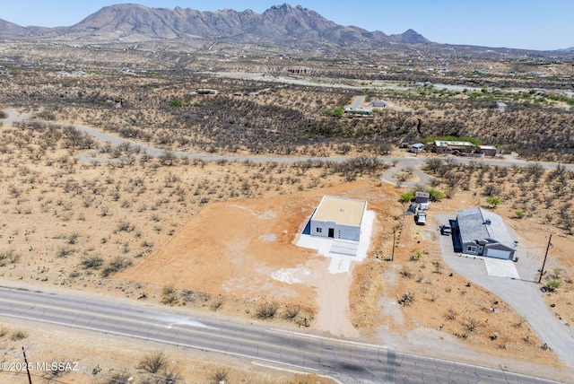 birds eye view of property featuring a mountain view, a rural view, and view of desert