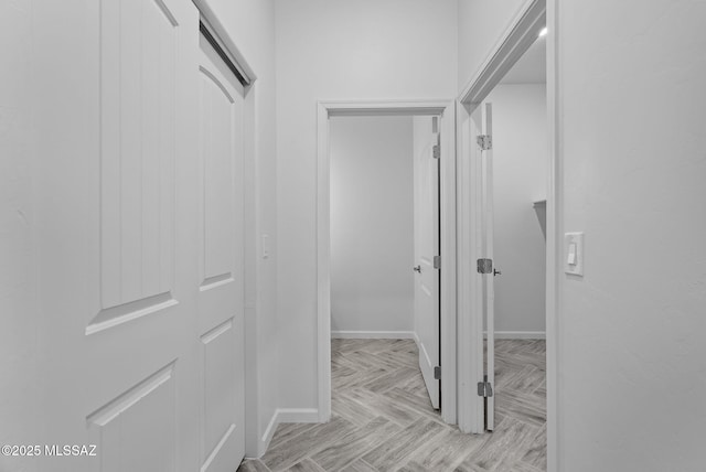 hall featuring baseboards