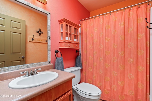 full bath featuring vanity and toilet