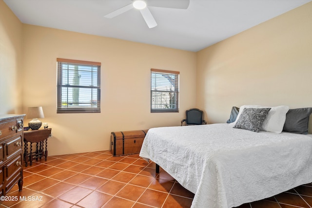 bedroom featuring ceiling fan and tile patterned flooring