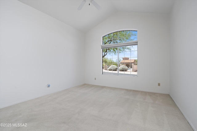 empty room with a ceiling fan, light carpet, and lofted ceiling