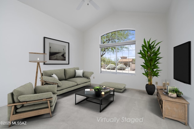 carpeted living room featuring a ceiling fan and vaulted ceiling