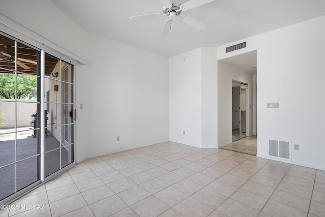 empty room featuring visible vents, a ceiling fan, and light tile patterned floors