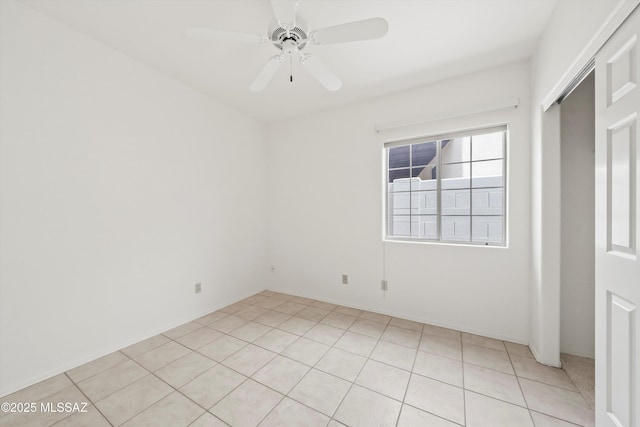 spare room with light tile patterned floors and ceiling fan