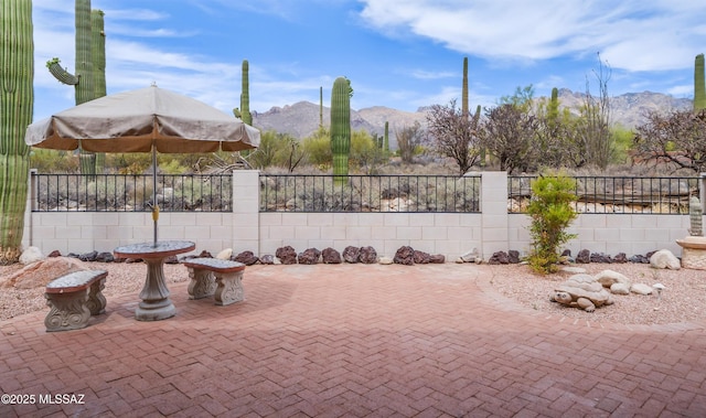 view of patio featuring a mountain view and fence private yard