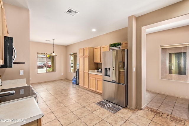 kitchen with light brown cabinets, light tile patterned floors, light countertops, appliances with stainless steel finishes, and visible vents