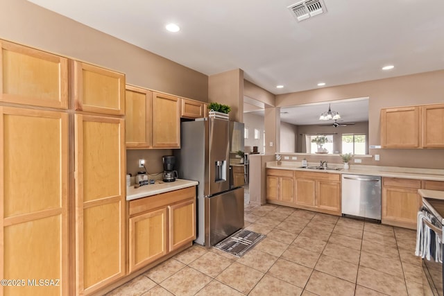 kitchen with light countertops, visible vents, stainless steel appliances, and a sink