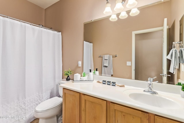 bathroom with vanity, a shower with shower curtain, and toilet