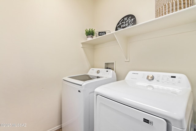 clothes washing area featuring washer and dryer and laundry area
