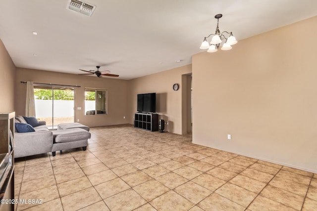 living area featuring visible vents, light tile patterned floors, and ceiling fan with notable chandelier