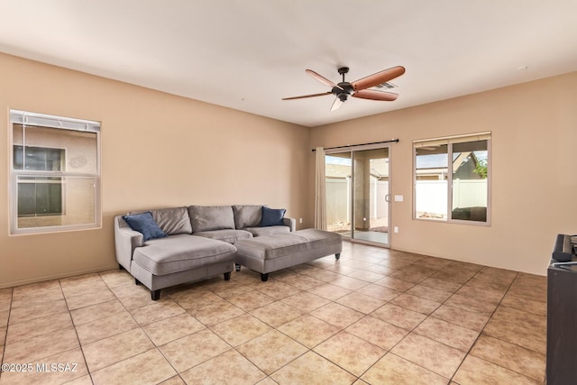 living room with a ceiling fan and light tile patterned floors