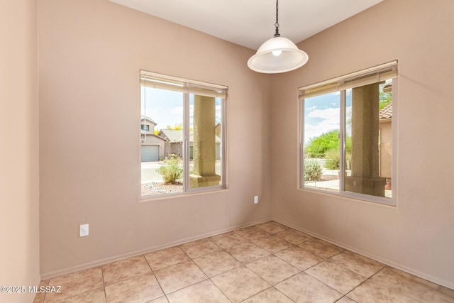 unfurnished room with a wealth of natural light and baseboards