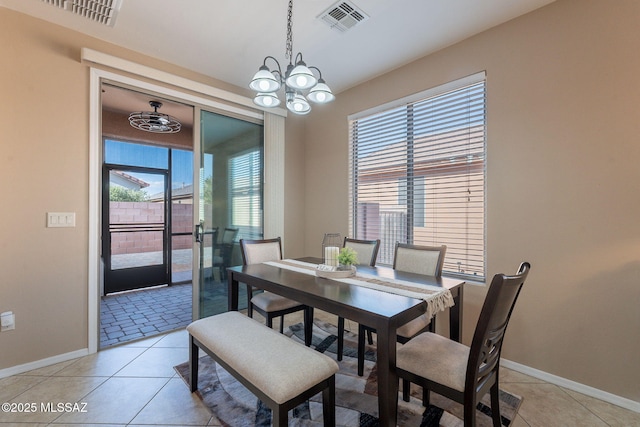 dining area featuring baseboards, visible vents, and a wealth of natural light