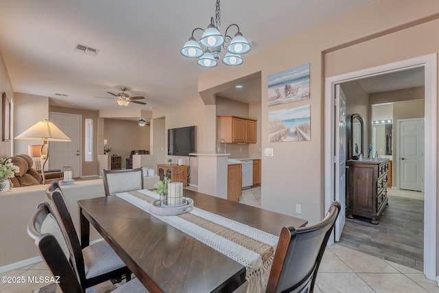 dining space featuring ceiling fan with notable chandelier, visible vents, and light tile patterned flooring