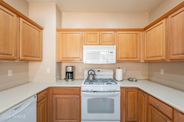 kitchen featuring light countertops and white appliances