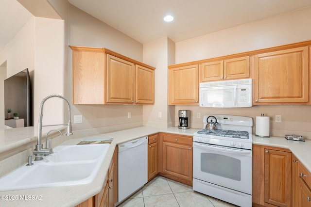 kitchen featuring a sink, recessed lighting, white appliances, light countertops, and light tile patterned floors