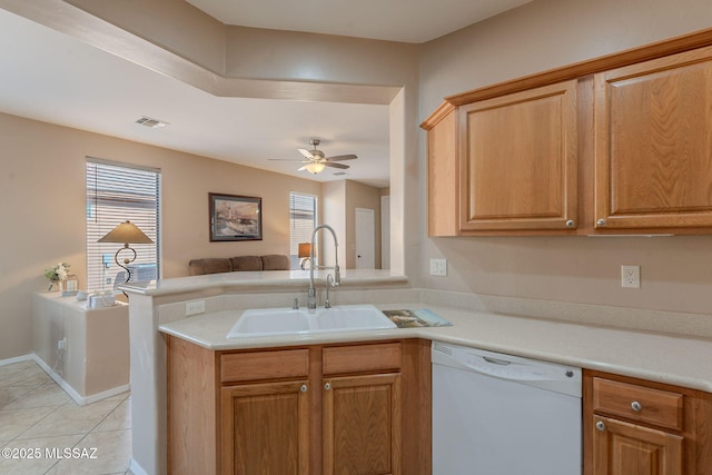 kitchen with a ceiling fan, light tile patterned floors, white dishwasher, a sink, and open floor plan