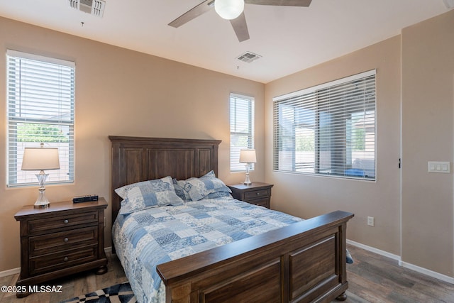 bedroom with baseboards, visible vents, and dark wood-style floors