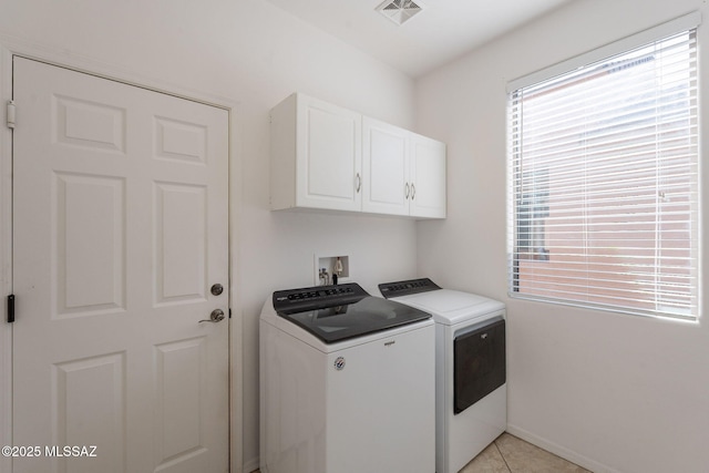 washroom with cabinet space, light tile patterned flooring, visible vents, and independent washer and dryer