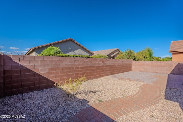 view of yard featuring a patio area and a fenced backyard
