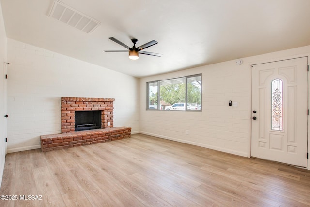 unfurnished living room featuring baseboards, a ceiling fan, visible vents, and light wood-style floors