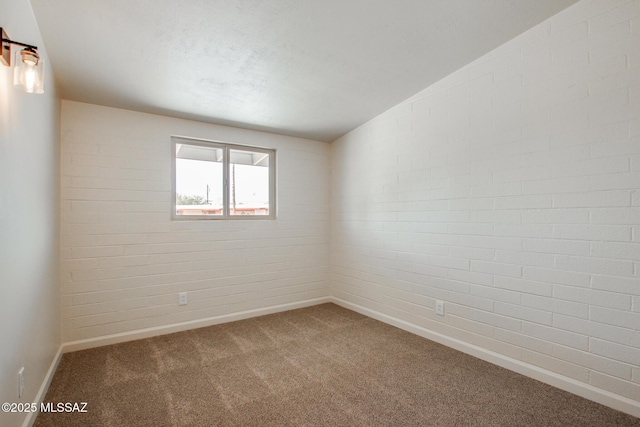 empty room featuring baseboards and carpet flooring