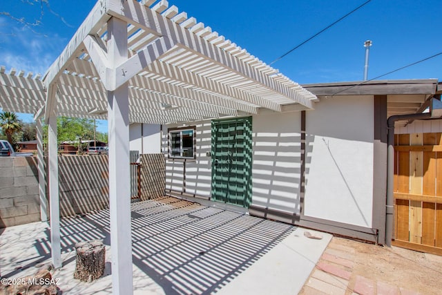 view of patio / terrace with fence and a pergola