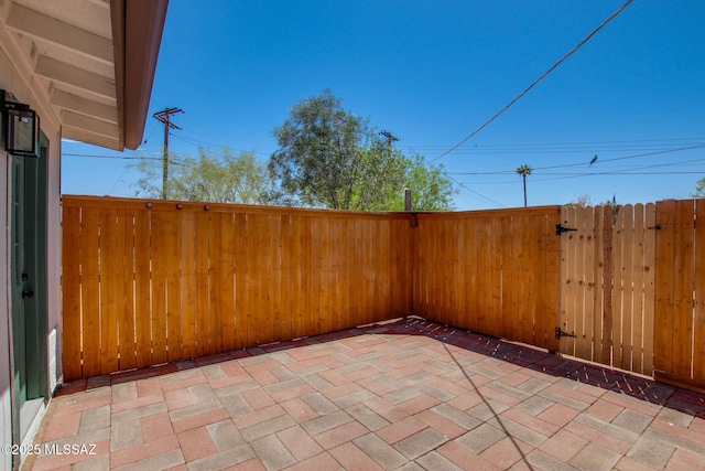 view of patio with a gate and fence