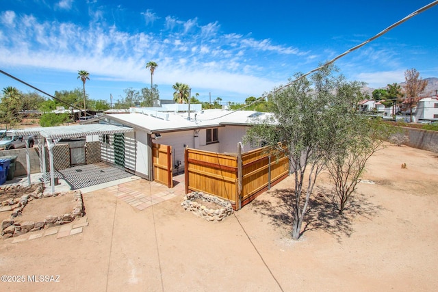 view of front of property with fence and a patio area