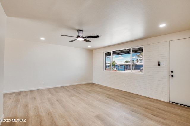 empty room featuring recessed lighting, brick wall, light wood finished floors, and ceiling fan