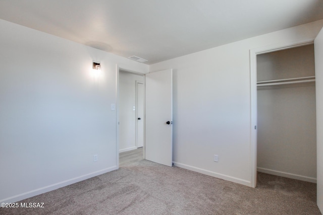unfurnished bedroom featuring baseboards, visible vents, a closet, and carpet flooring