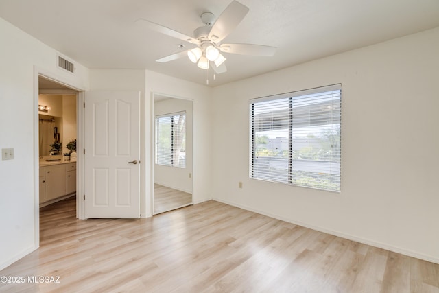 unfurnished bedroom featuring baseboards, visible vents, and light wood-type flooring