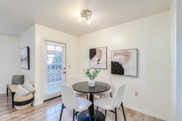 dining room featuring baseboards and light wood-style flooring