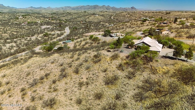 drone / aerial view with a rural view, view of desert, and a mountain view