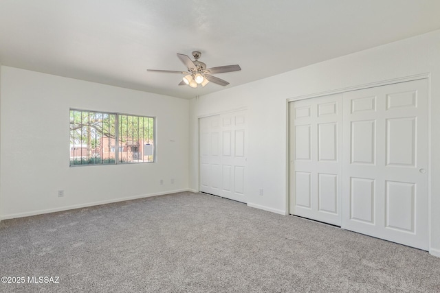 8341 E Placita Prado, Tucson, AZ 85710 - unfurnished bedroom featuring multiple closets, carpet, baseboards, and a ceiling fan