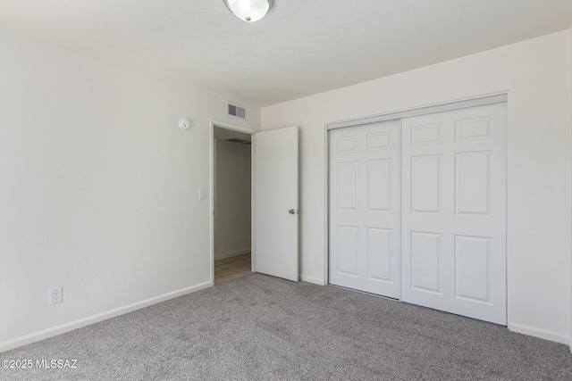 8341 E Placita Prado, Tucson, AZ 85710 - unfurnished bedroom with carpet floors, baseboards, and a closet