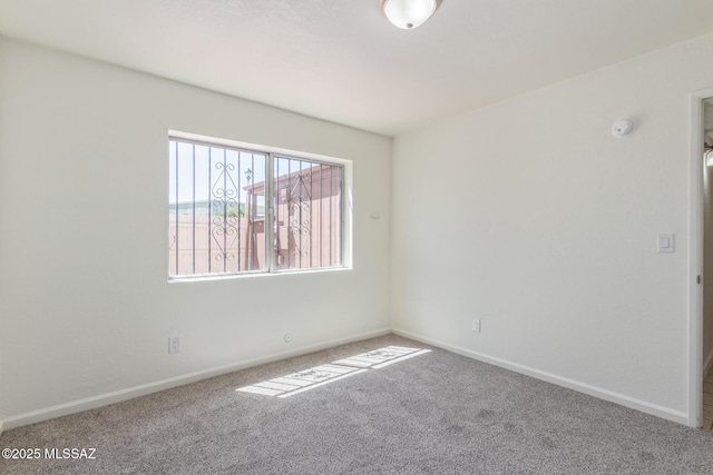 8341 E Placita Prado, Tucson, AZ 85710 - carpeted empty room featuring baseboards and a smoke detector